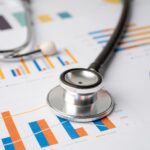 Stethoscope on charts and graphs paper.